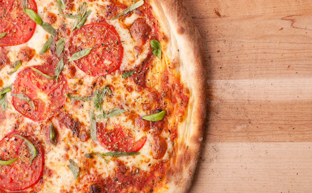 PIZZA WITH BASIL, FRESH TOMATOES AND MOZZARELLA